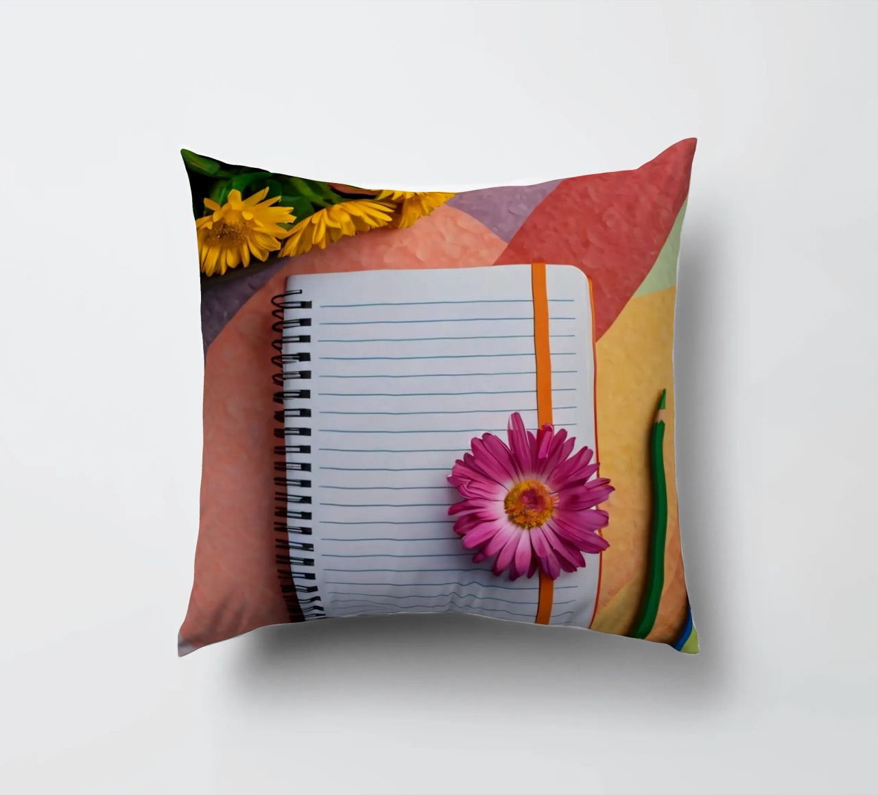 Uno spazio di lavoro colorato con un taccuino con un fiore cuscino da DesignDoodle
