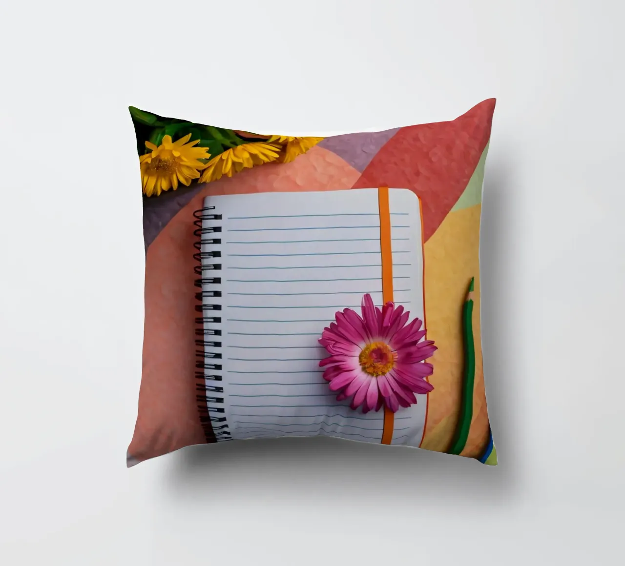 Uno spazio di lavoro colorato con un taccuino con un fiore cuscino da DesignDoodle