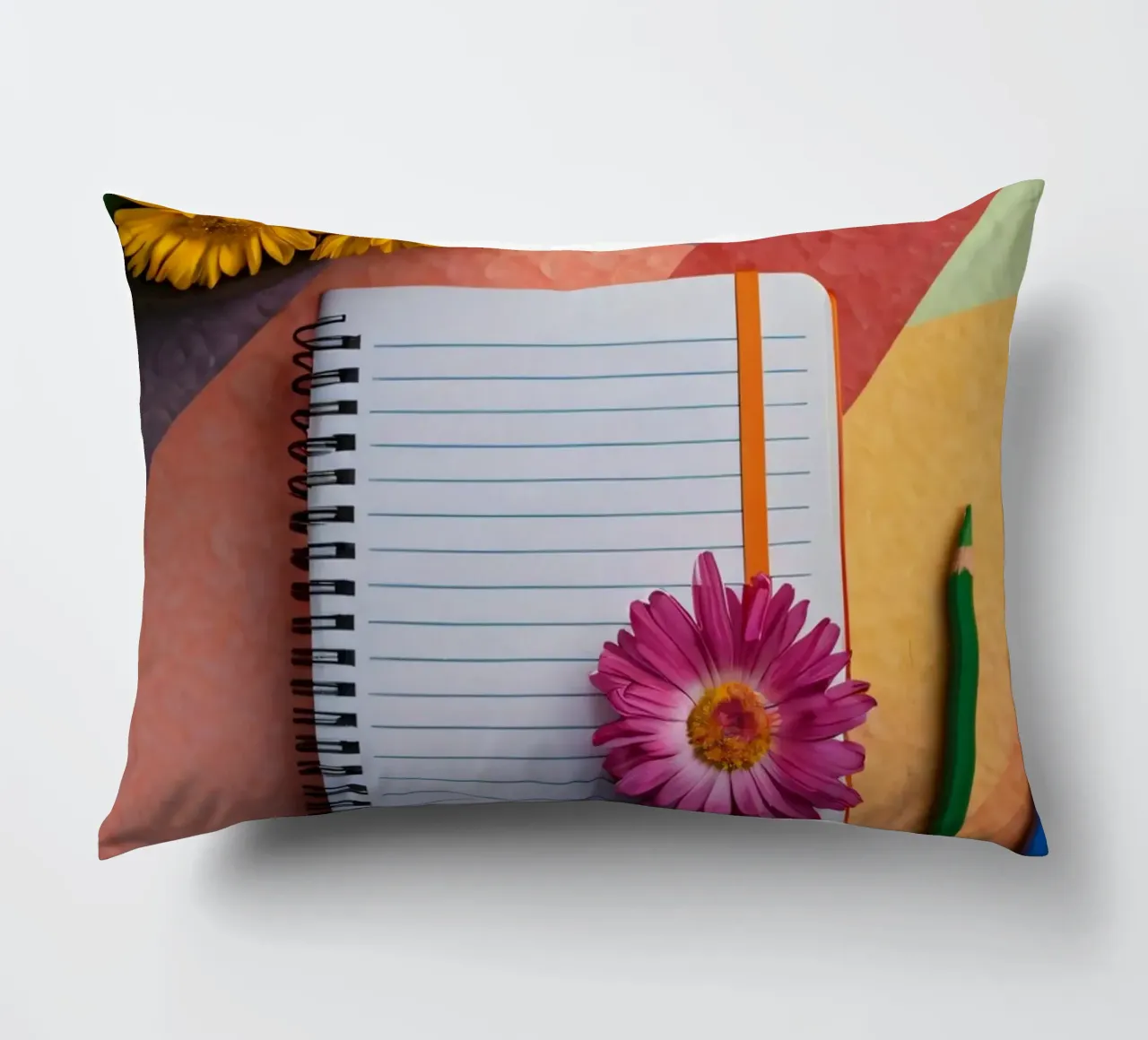 Uno spazio di lavoro colorato con un taccuino con un fiore cuscino da DesignDoodle