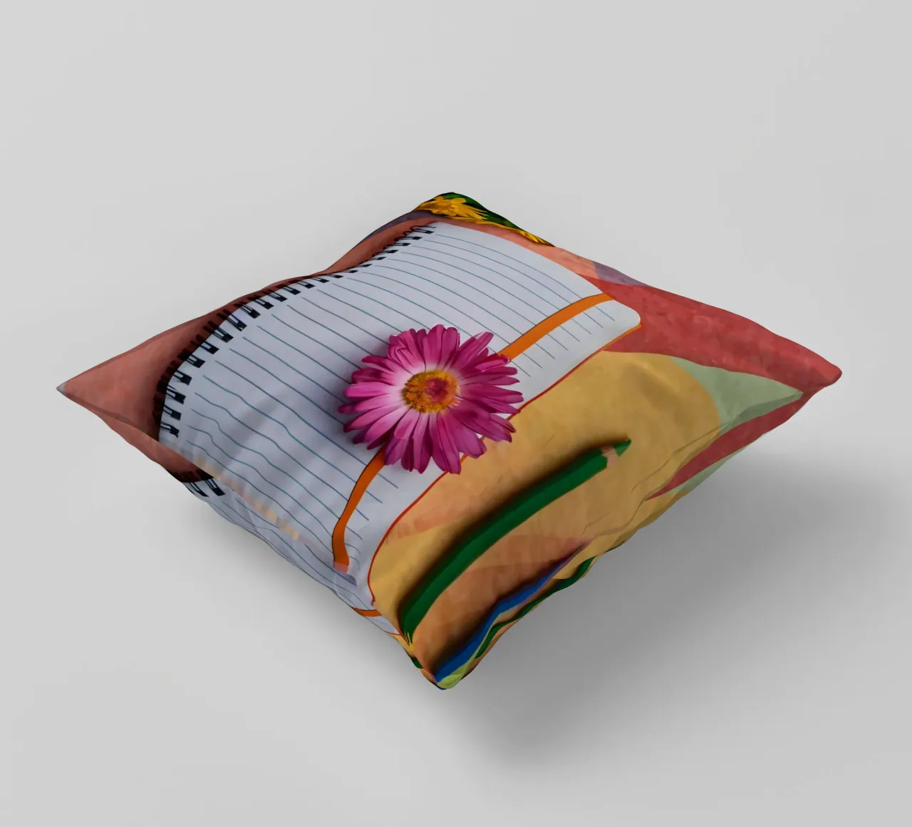 Espace de travail coloré comprenant un cahier avec une fleur coussin de DesignDoodle