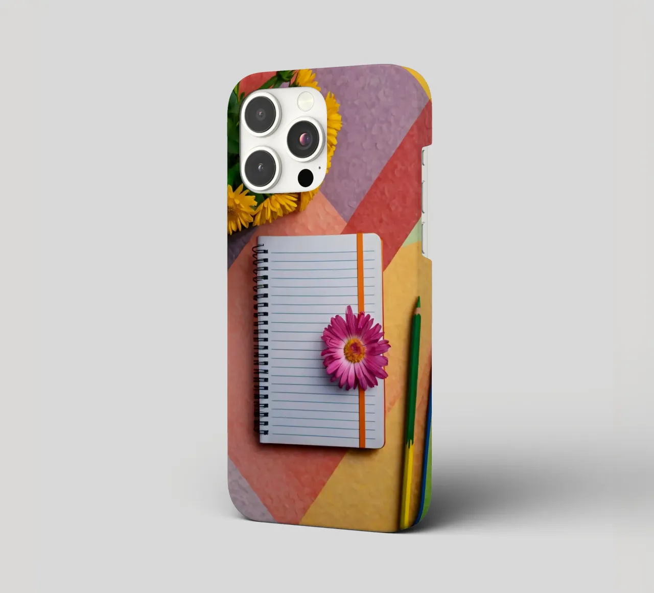 Uno spazio di lavoro colorato con un taccuino con un fiore cover iphone da DesignDoodle