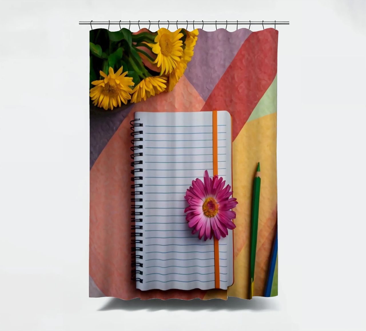 Uno spazio di lavoro colorato con un taccuino con un fiore tenda da doccia da DesignDoodle