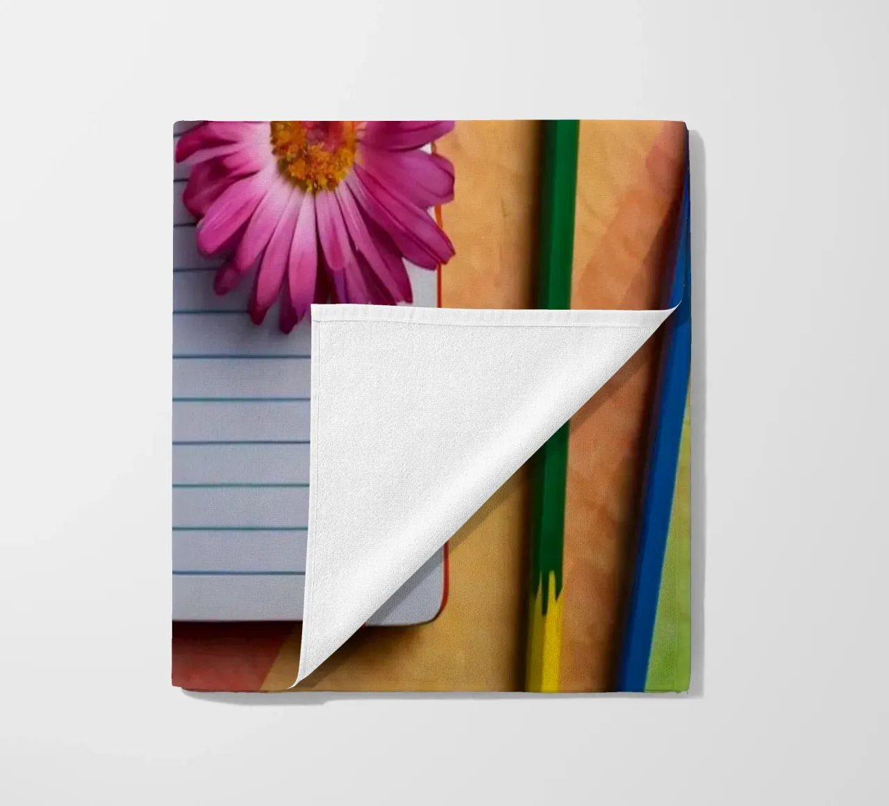 Colorful workspace featuring a notebook with a flower beach towel by DesignDoodle