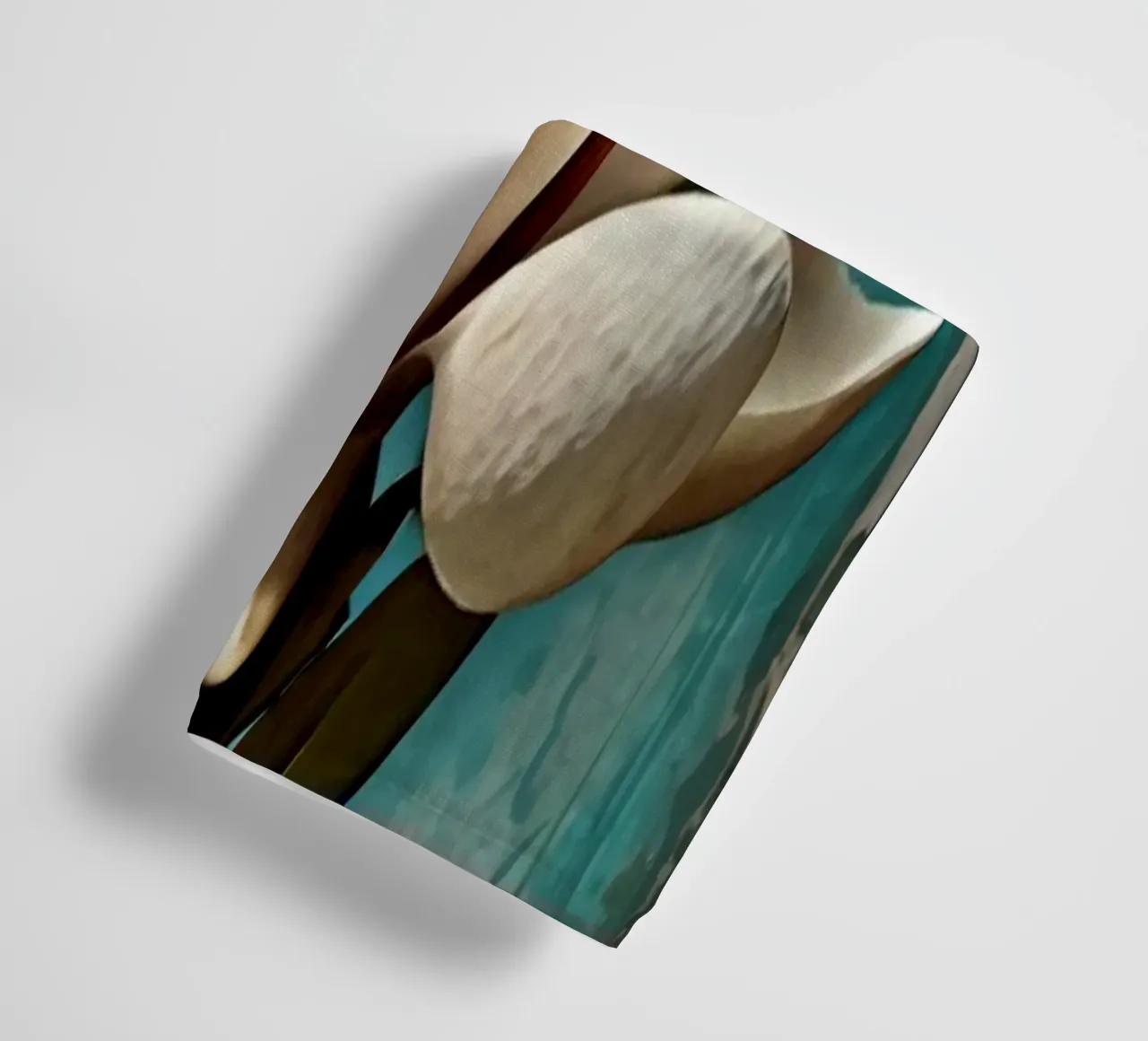 Elegant white magnolia blossom stands out against a textured towel by DesignDoodle