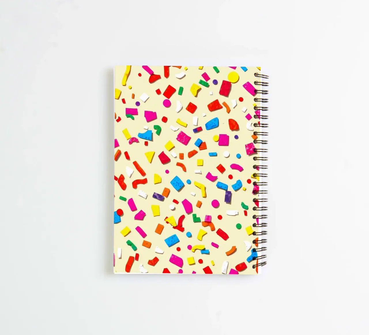 Colorful abstract design featuring vibrant shapes on a light spiral notebook by DesignDoodle