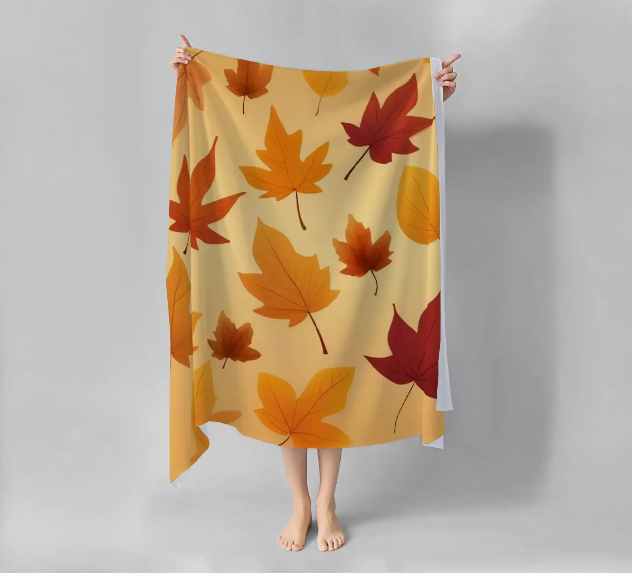 autumn leaves in warm hues creating an abstract background beach towel by DesignDoodle