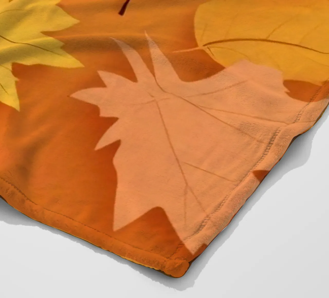 autumn leaves forming an abstract pattern on a warm orange fleece blanket by DesignDoodle