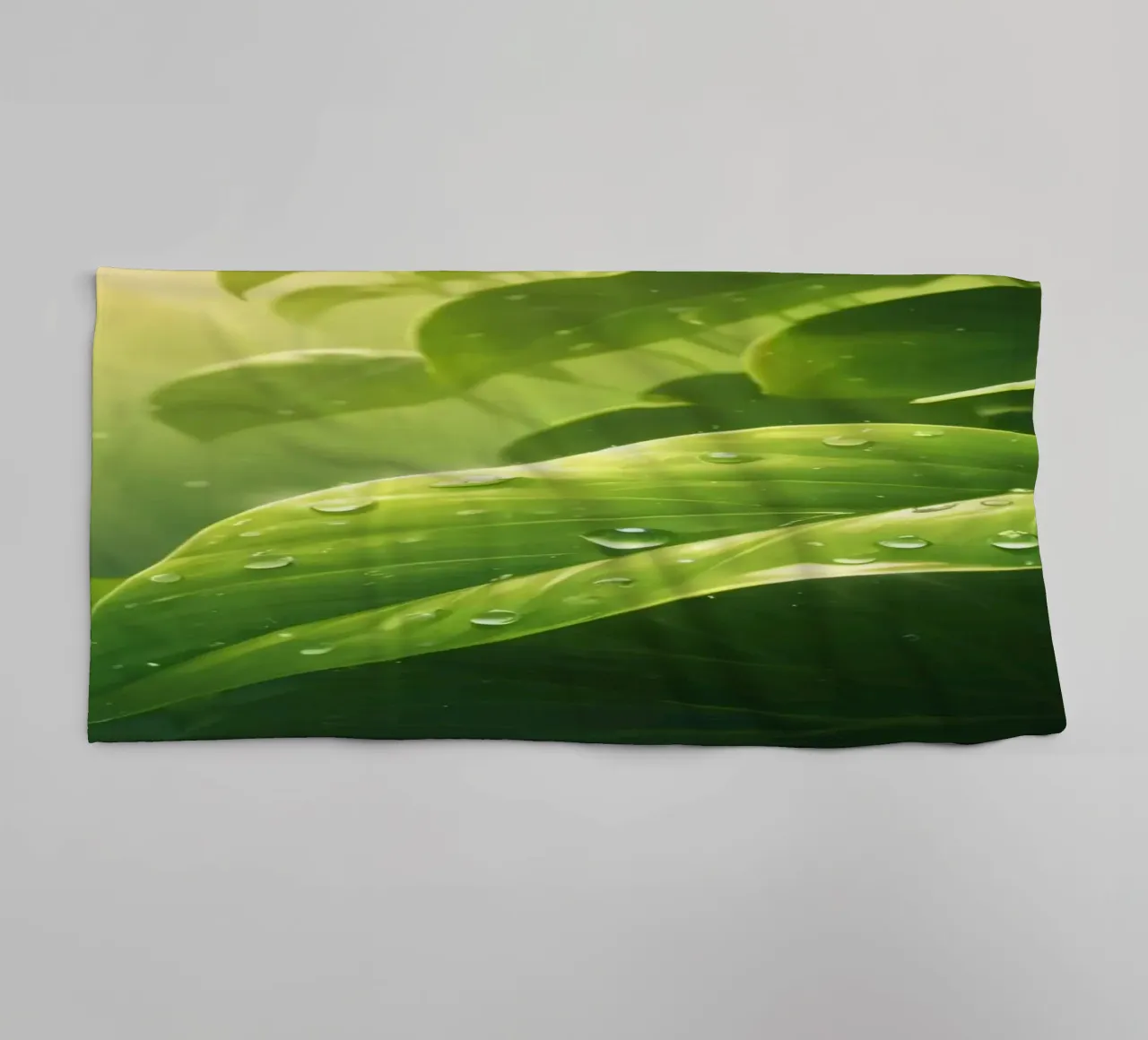 Lush greenery with sparkling droplet illuminated by sunlight towel by DesignDoodle