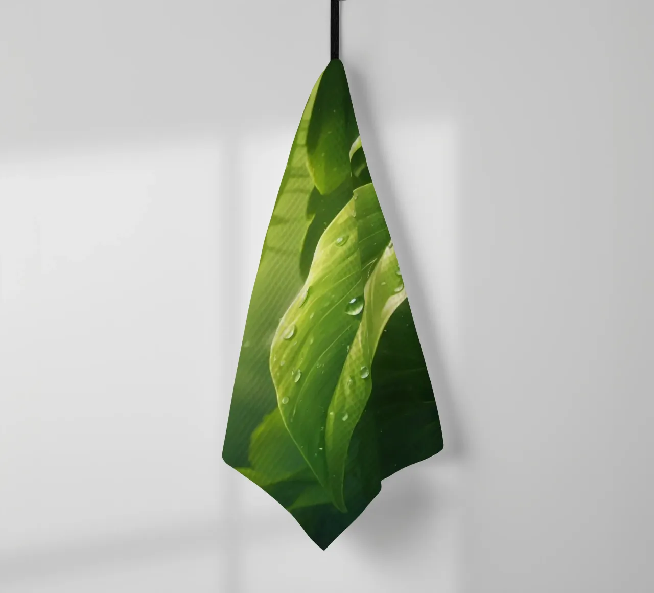 Lush greenery with sparkling droplet illuminated by sunlight tea towel by DesignDoodle