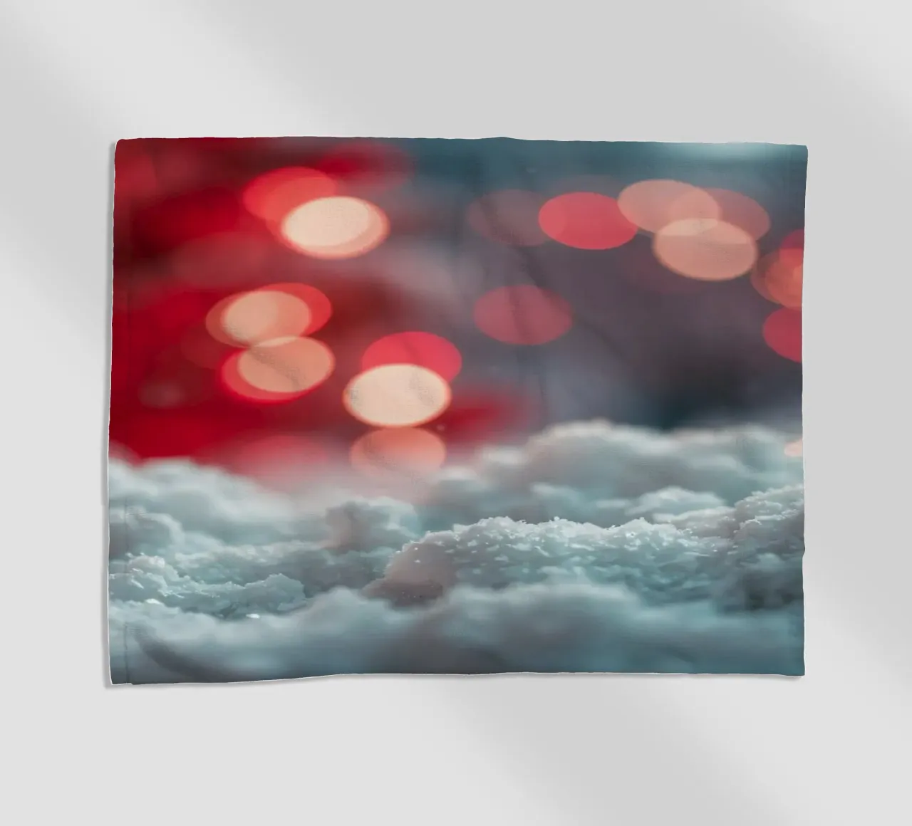 Luminose luci natalizie illuminano la neve soffice telo mare da DesignDoodle