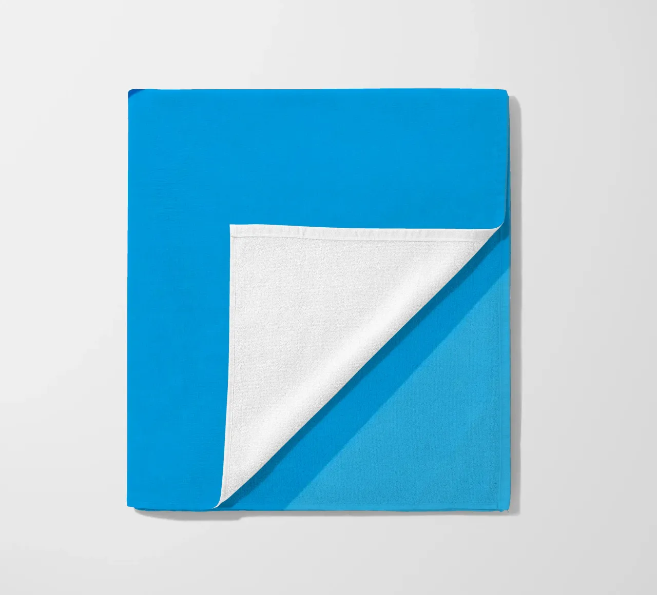 abstract blue design provides a captivating backdrop beach towel by DesignDoodle