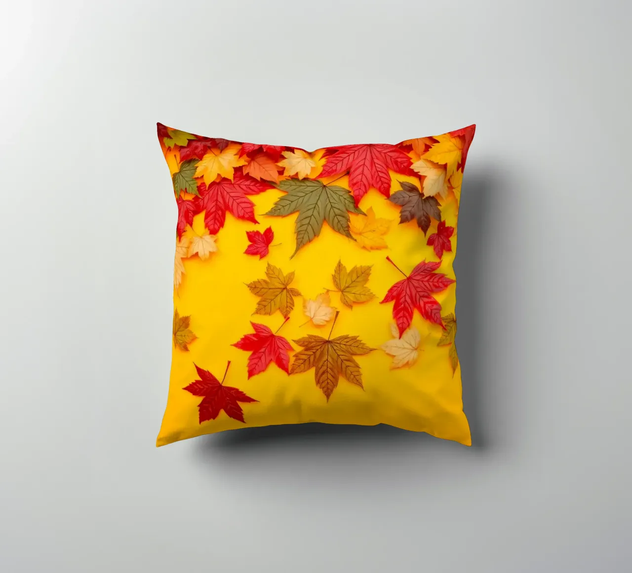 foglie autunnali sparse su uno sfondo giallo caldo cuscino da DesignDoodle