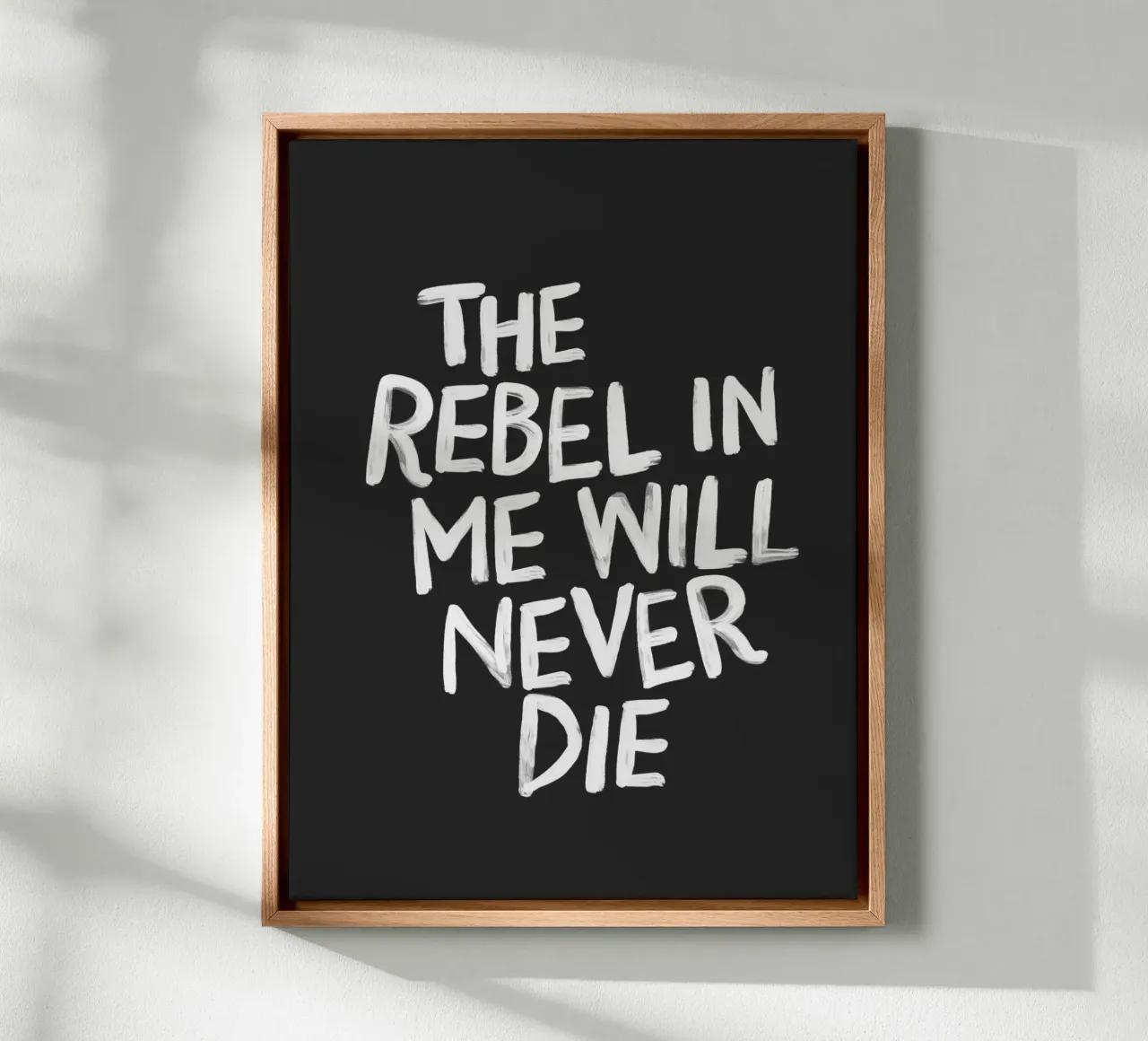 The Rebel in Me Will Never Die Black Typography Print canvas with Floater frame by THE MOTIVATED TYPE