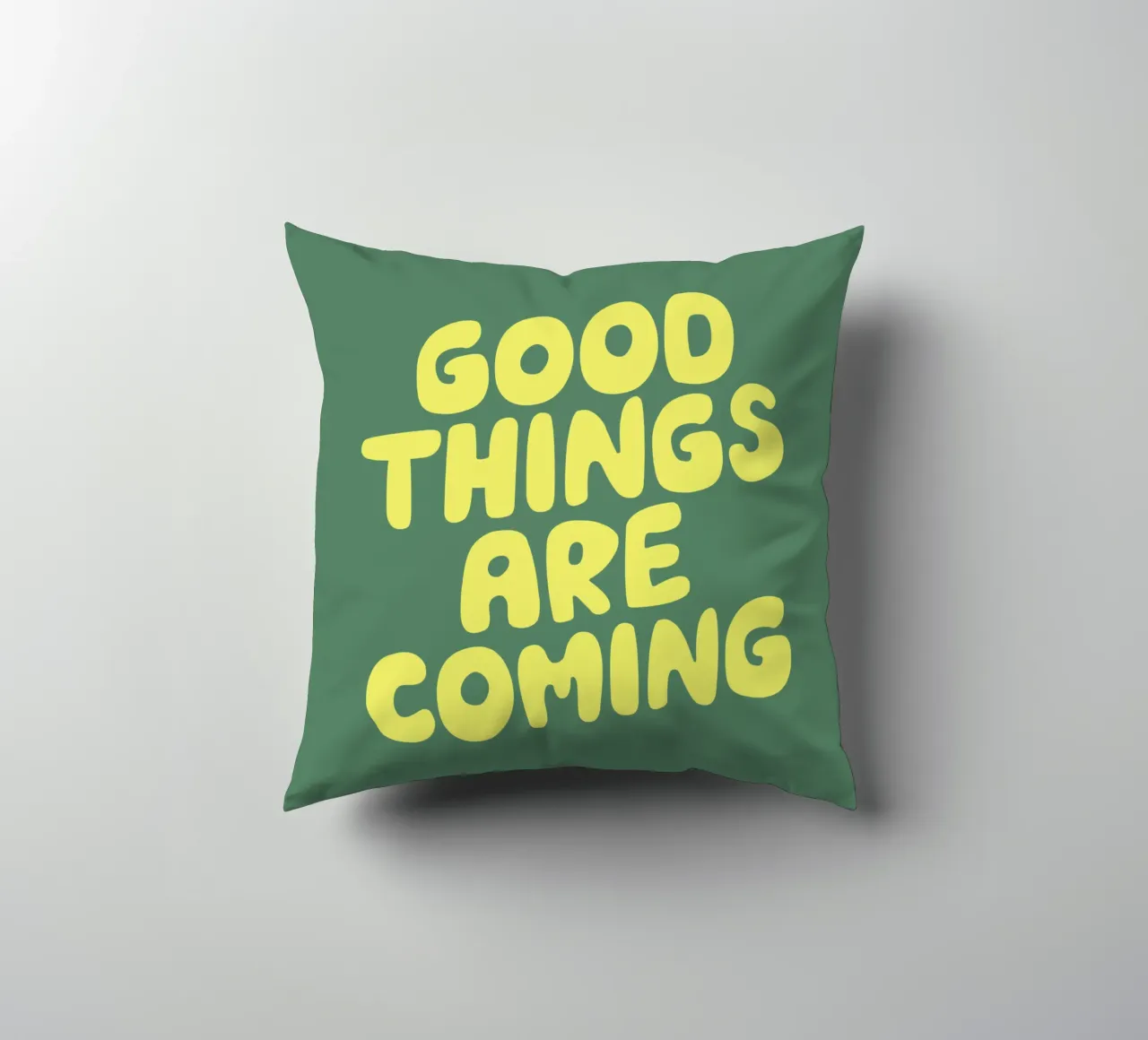 Good Things Are Coming Typography Print in Green and Yellow decorative cushion by THE MOTIVATED TYPE