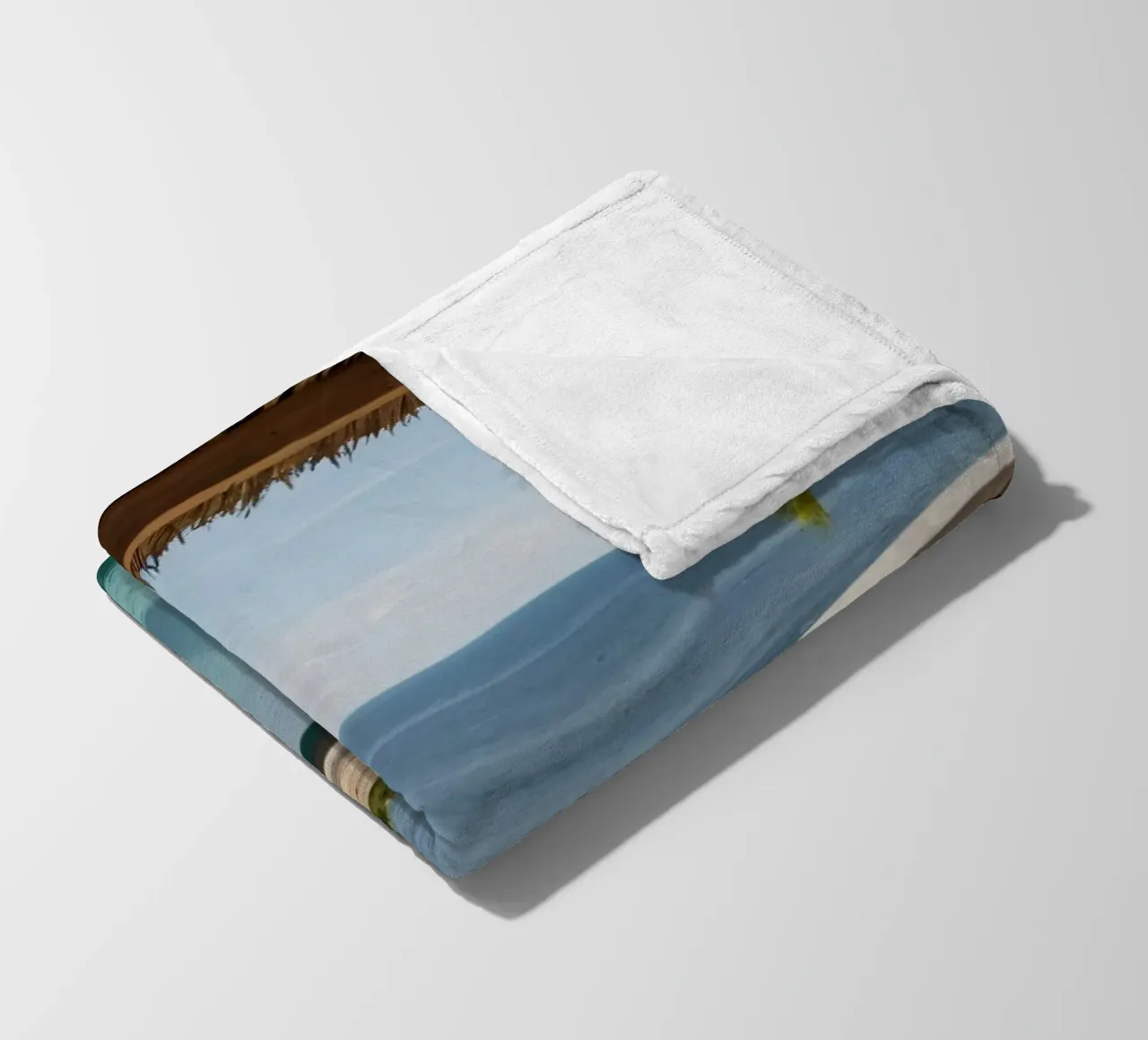 Relaxing by the tranquil poolside with ocean view fleece blanket by DesignDoodle