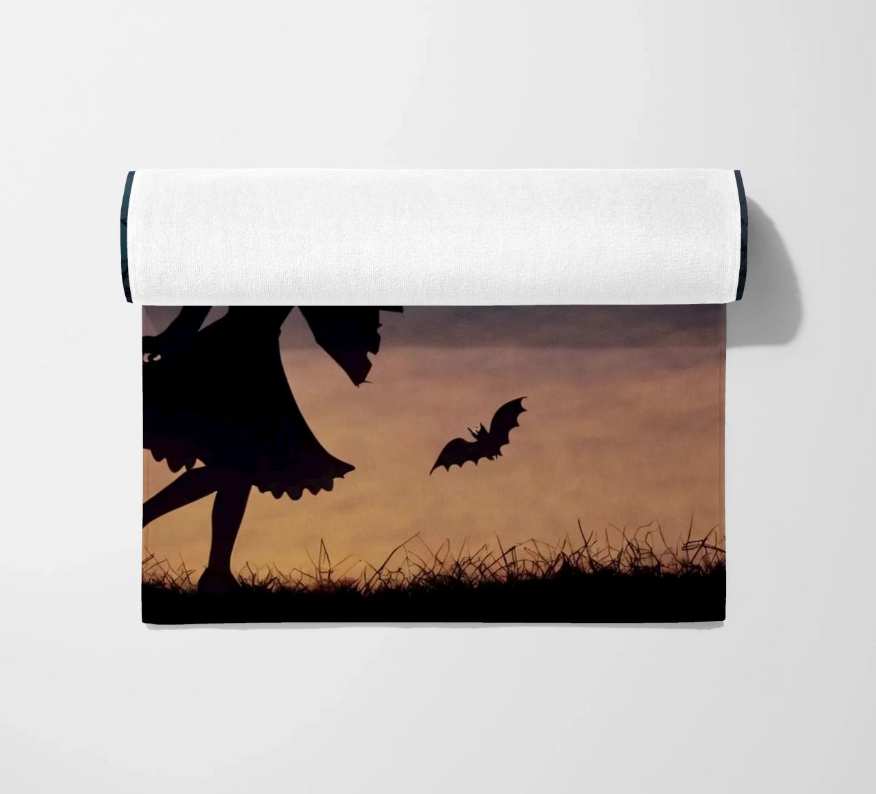 Una strega in controluce che vola su un manico di scopa in un pipistrello crepuscolare telo mare da DesignDoodle