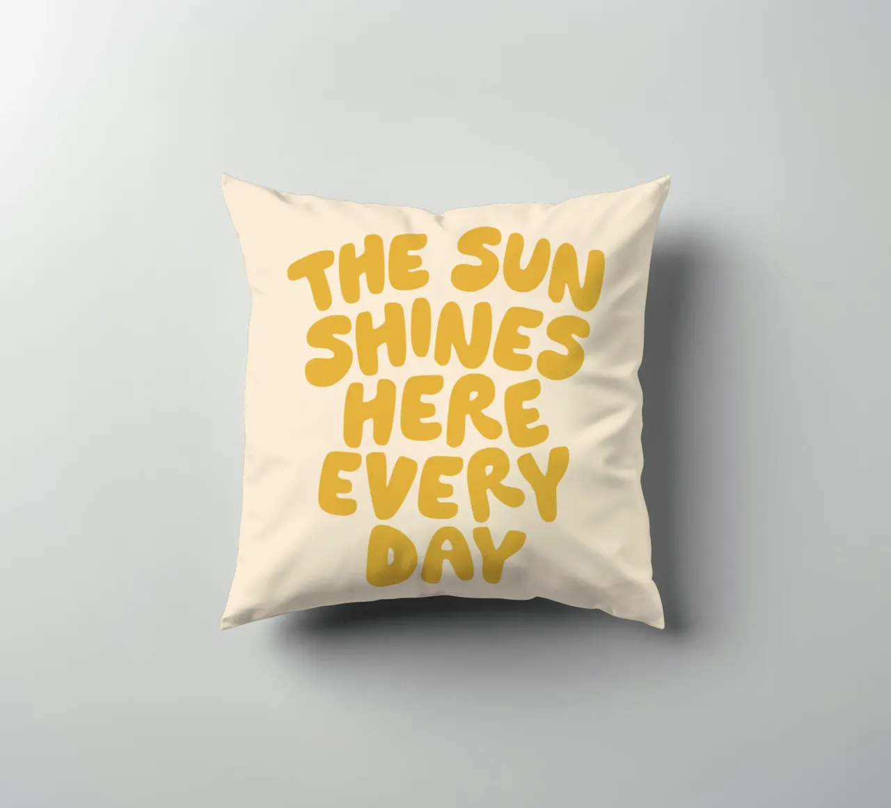 The Sun Shines Here Every Day Typography Print in Yellow decorative cushion by THE MOTIVATED TYPE