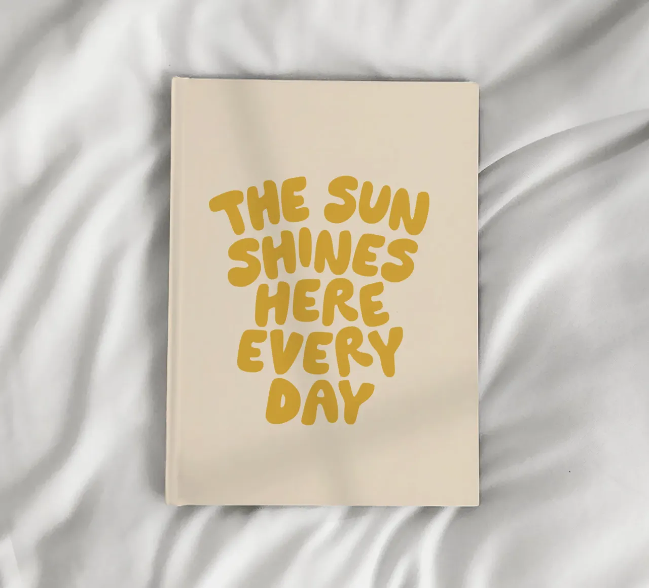 The Sun Shines Here Every Day Typography Print in Yellow notebook by THE MOTIVATED TYPE