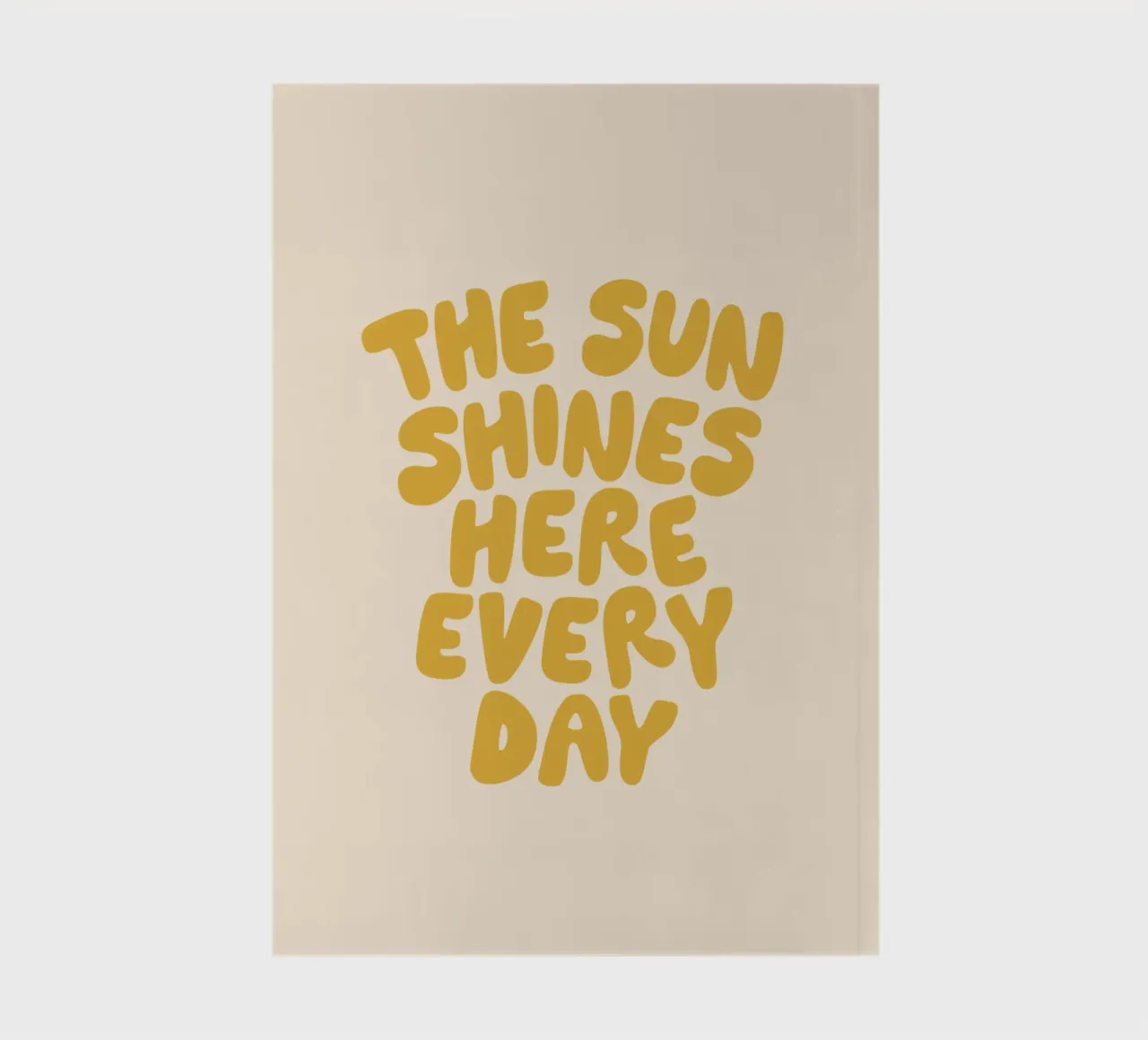 The Sun Shines Here Every Day Typography Print in Yellow notebook by THE MOTIVATED TYPE
