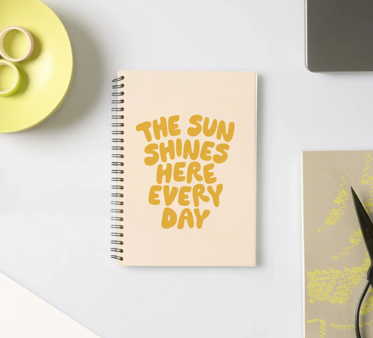 The Sun Shines Here Every Day Typography Print in Yellow spiral notebook by THE MOTIVATED TYPE