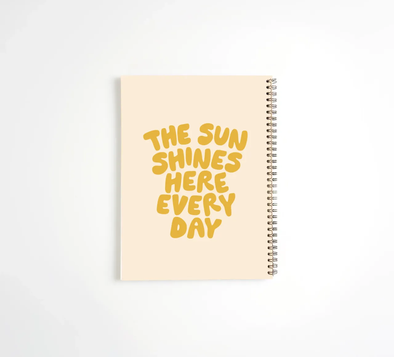 The Sun Shines Here Every Day Typography Print in Yellow spiral notebook by THE MOTIVATED TYPE