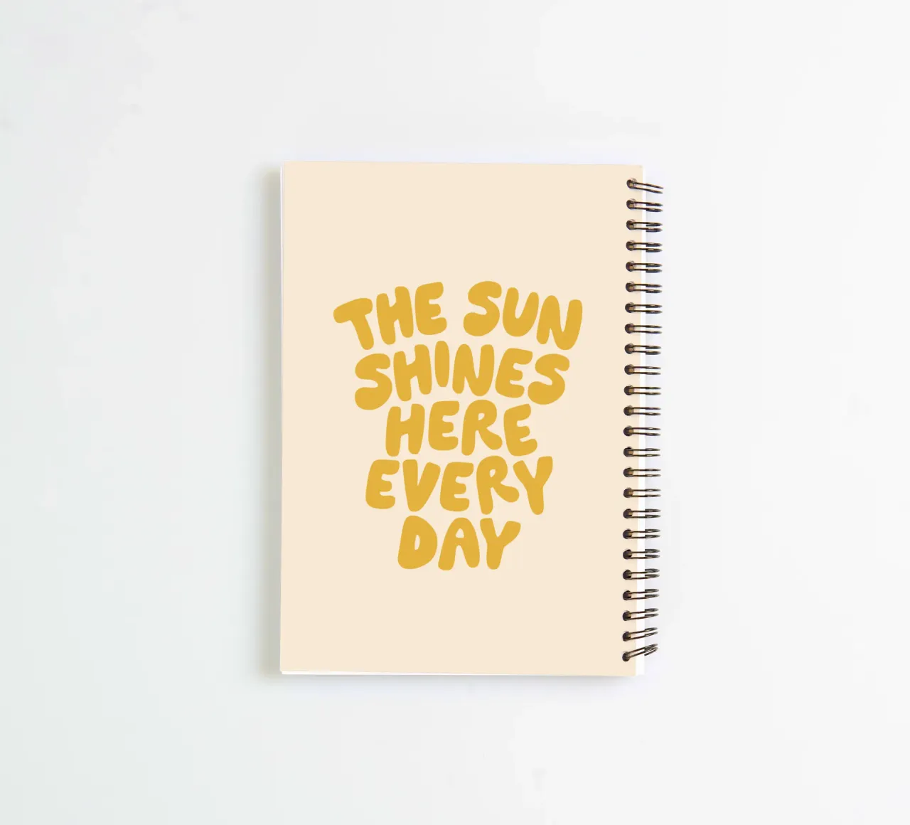 The Sun Shines Here Every Day Typography Print in Yellow spiral notebook by THE MOTIVATED TYPE