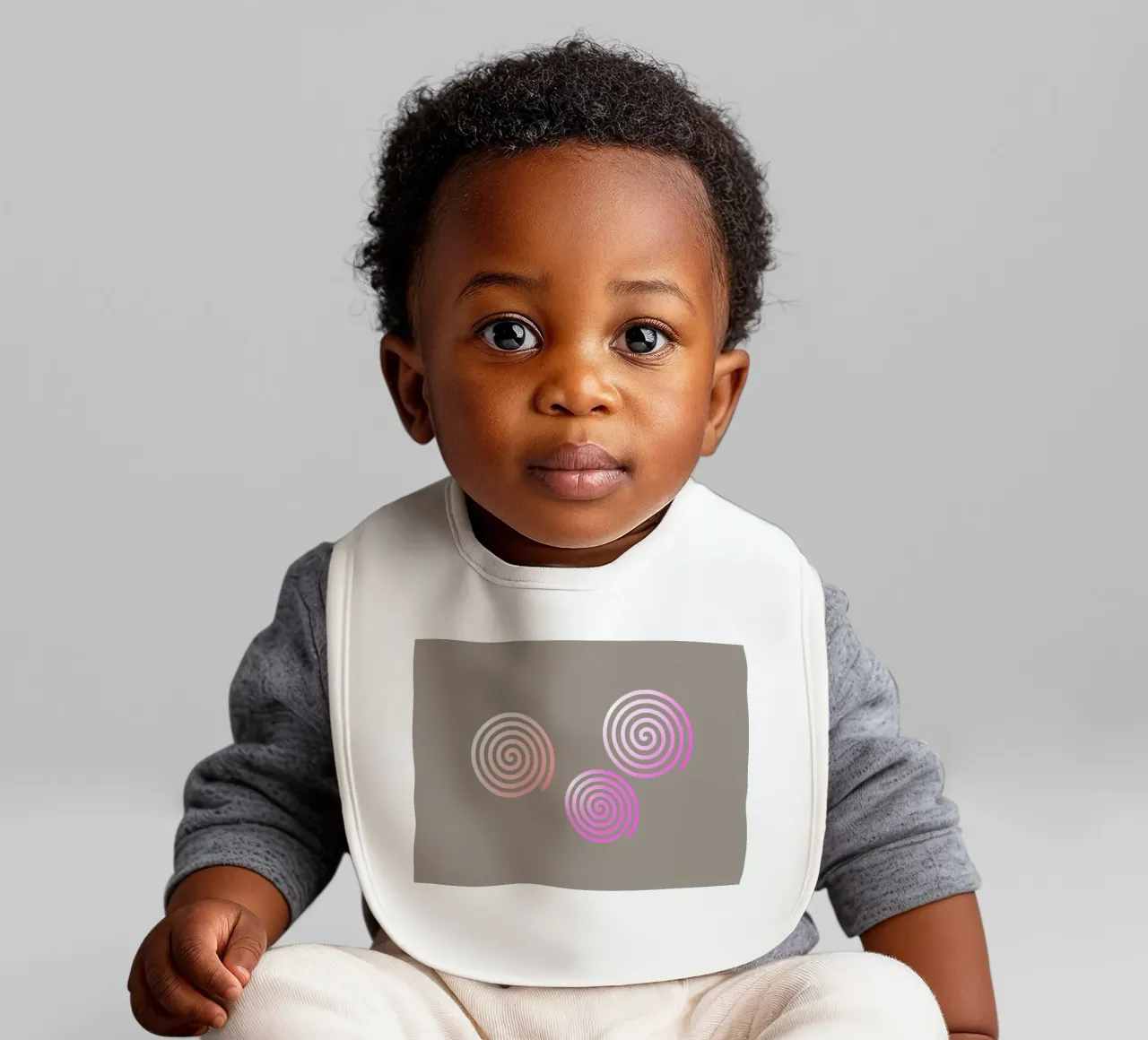 Three pink spirals on a grey background baby bib by Something for you