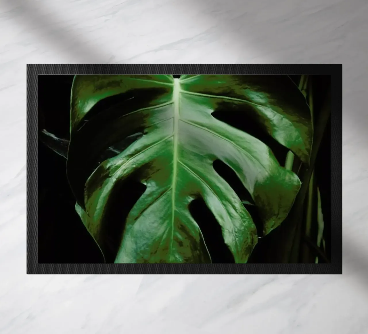 Monstera Leaf doormat by Ingrid Beddoes