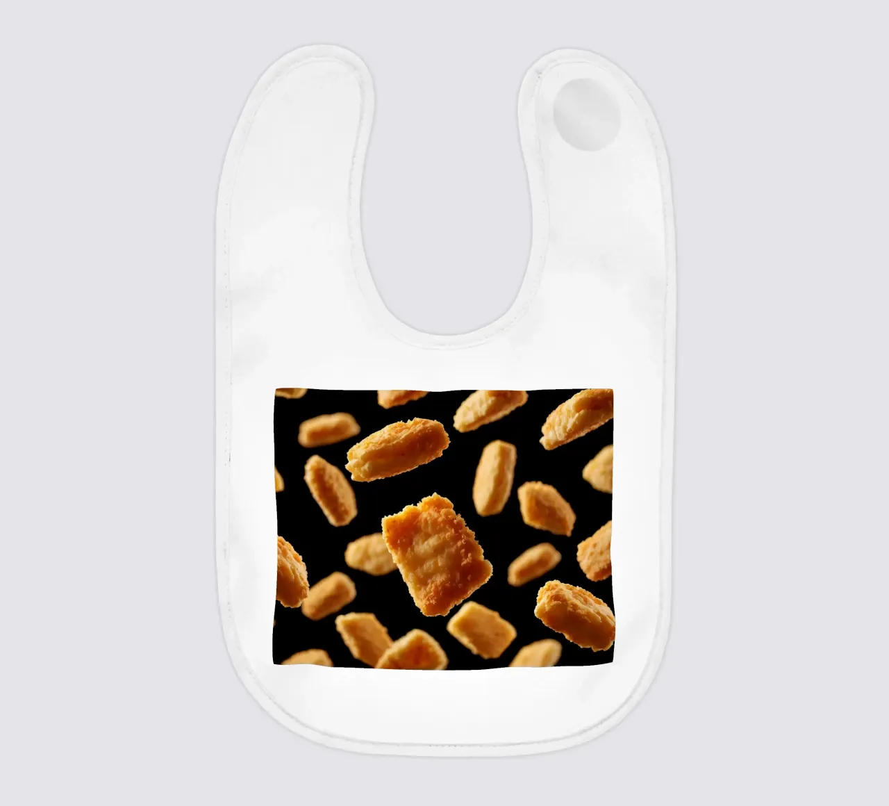 Nuggets in mid-air create a dynamic culinary display baby bib by DesignDoodle
