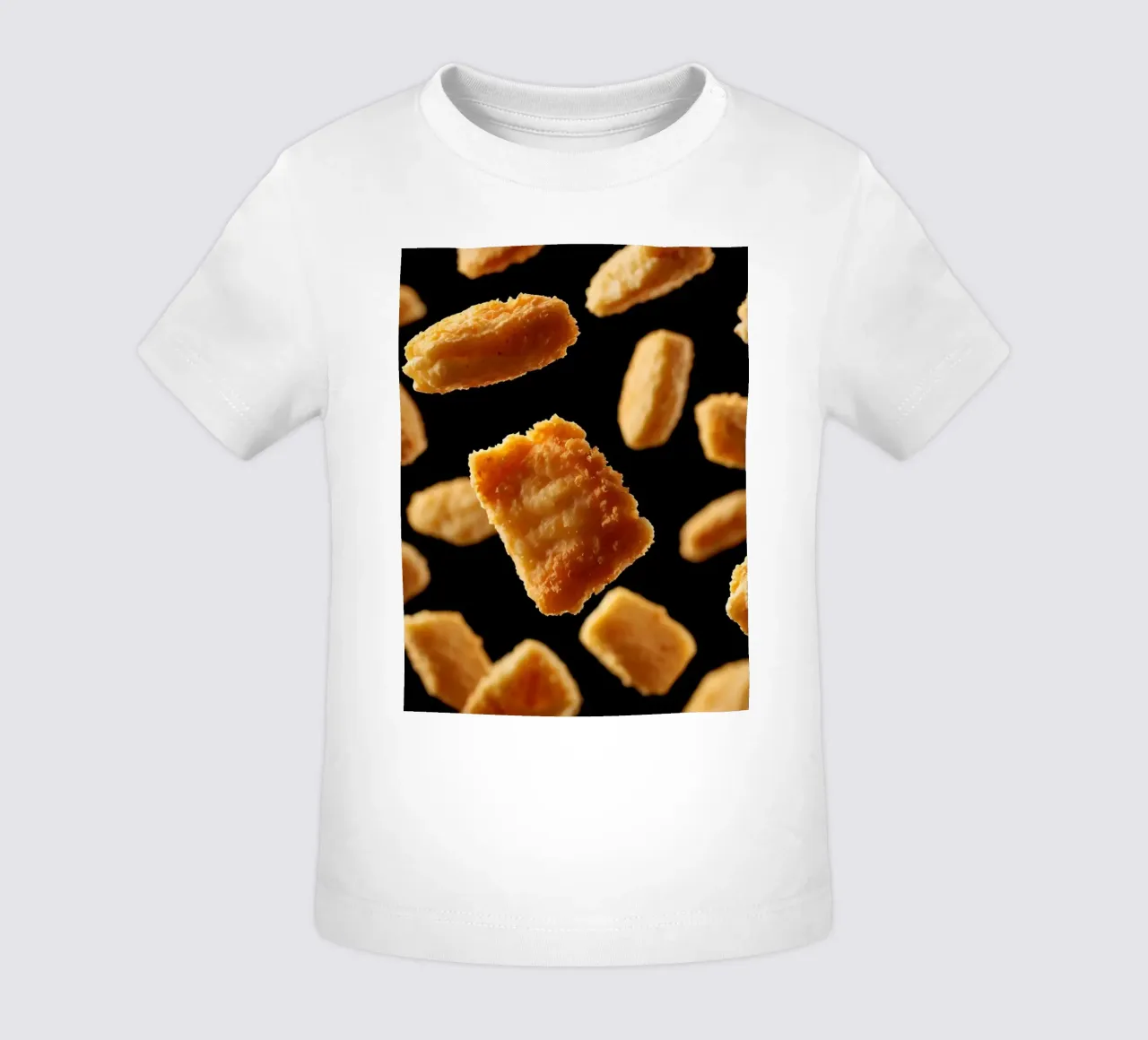 Nuggets in mid-air create a dynamic culinary display baby t-shirt by DesignDoodle