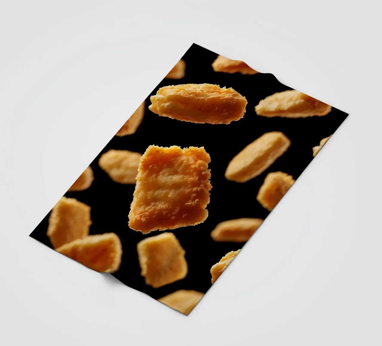 Nuggets in mid-air create a dynamic culinary display fleece blanket by DesignDoodle