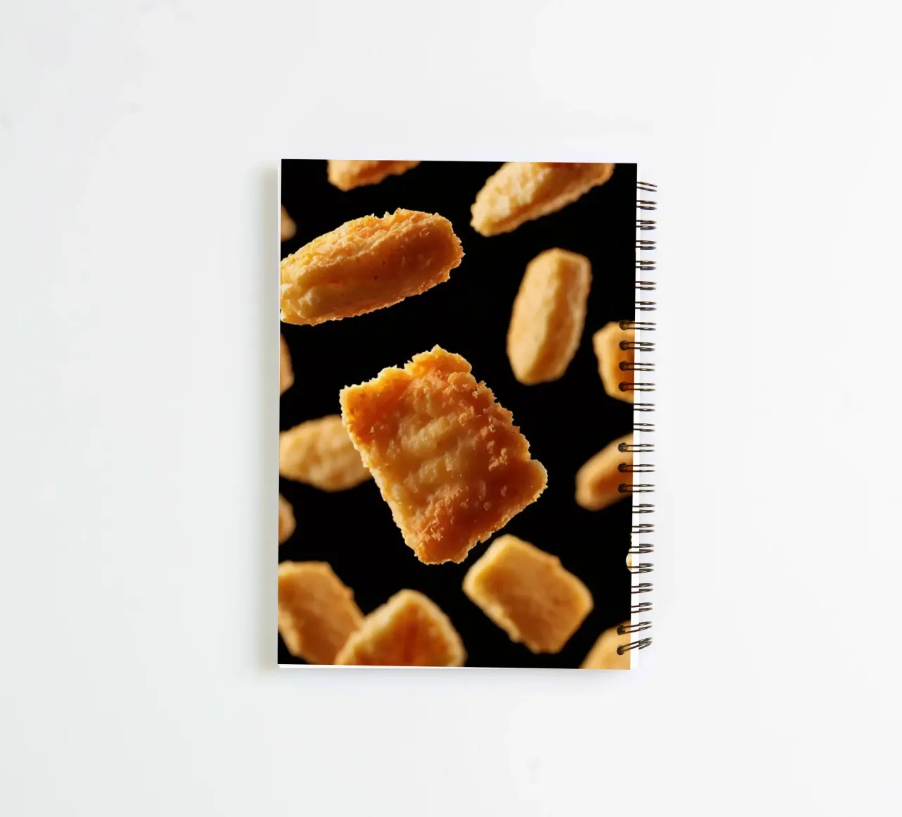 Nuggets in mid-air create a dynamic culinary display spiral notebook by DesignDoodle