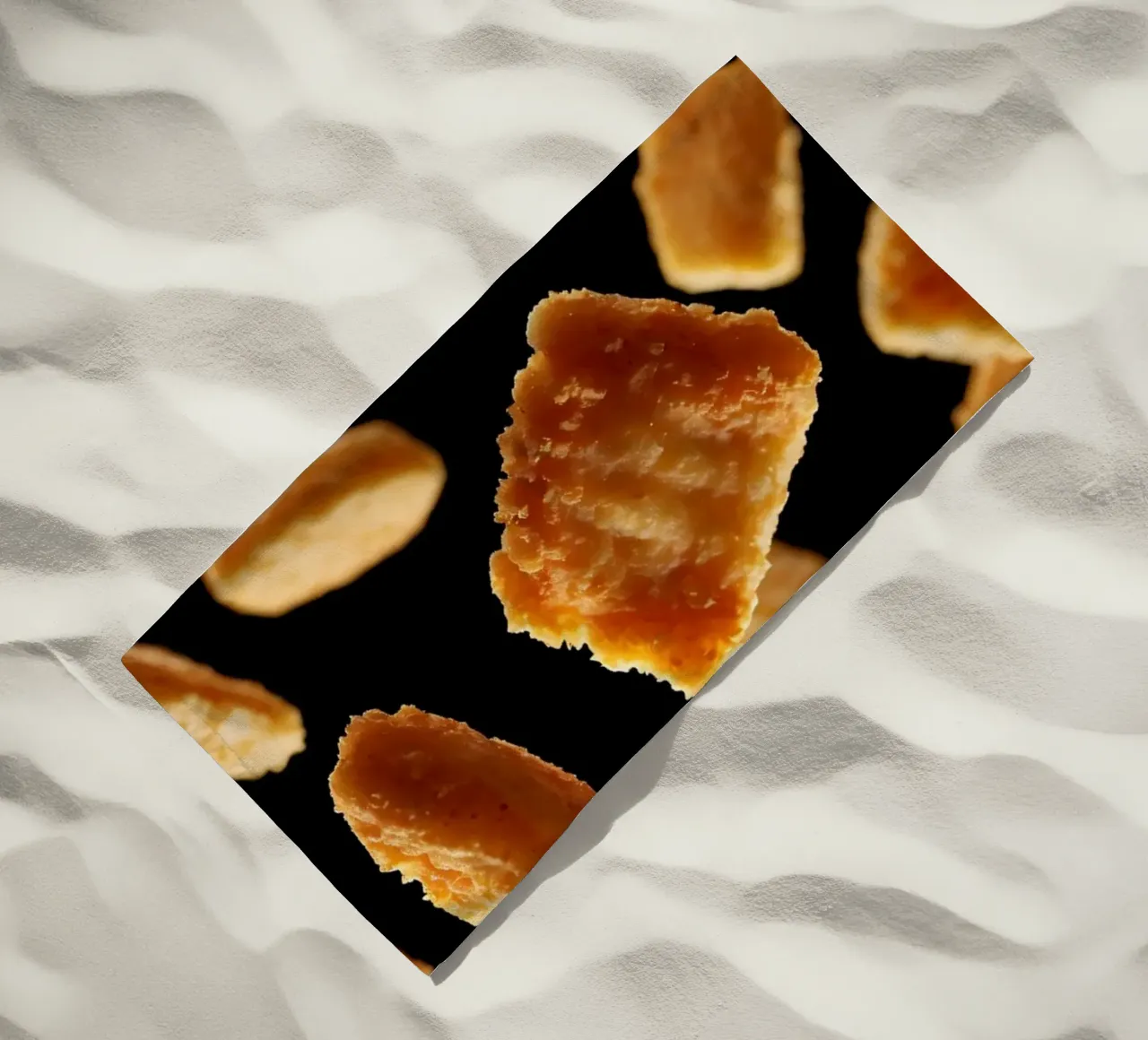 Nuggets in mid-air create a dynamic culinary display beach towel by DesignDoodle