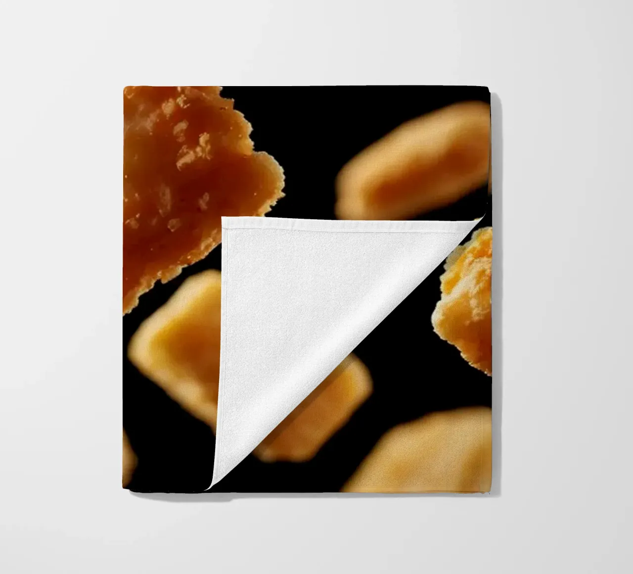 Nuggets in mid-air create a dynamic culinary display beach towel by DesignDoodle