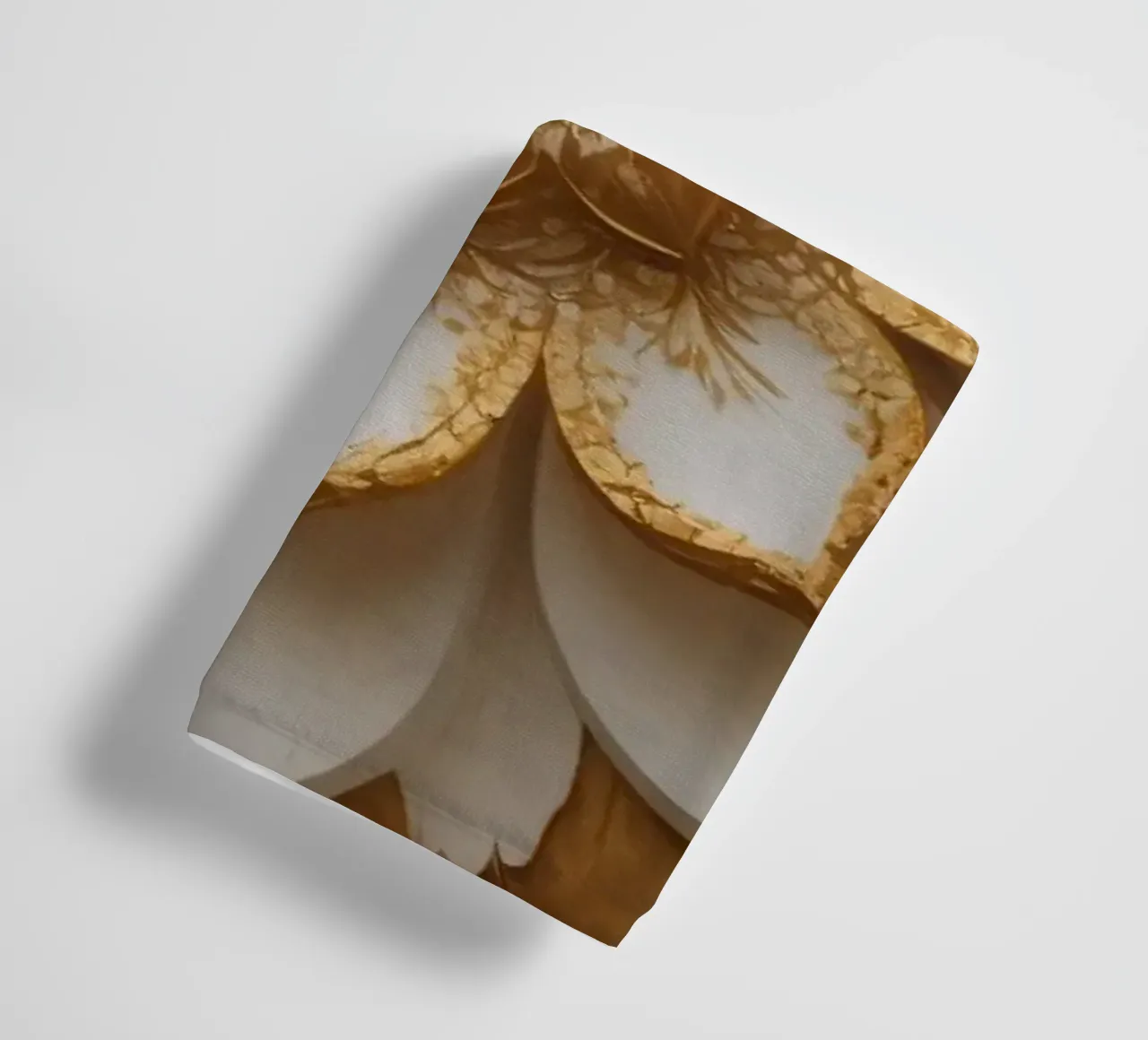 Decorative golden lotus flower design crafted on a textured towel by DesignDoodle