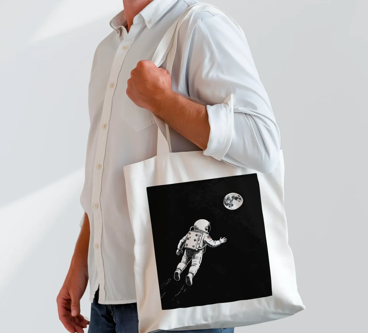 Astronaut floating towards the moon in a dark space tote bag by DesignDoodle