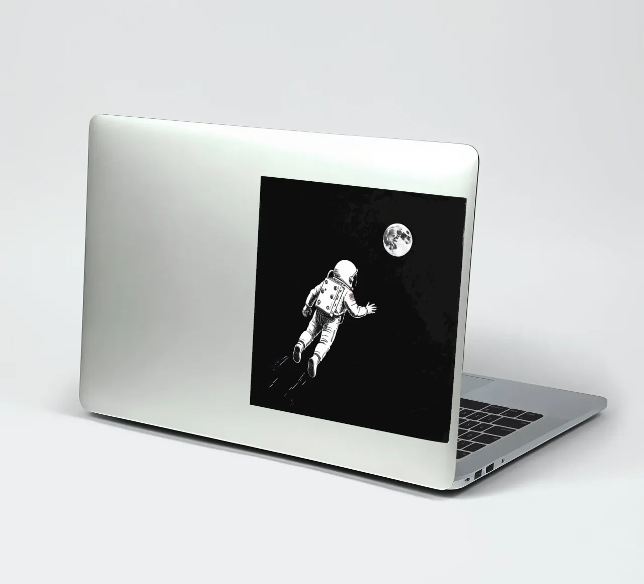 Astronaut floating towards the moon in a dark space sticker by DesignDoodle