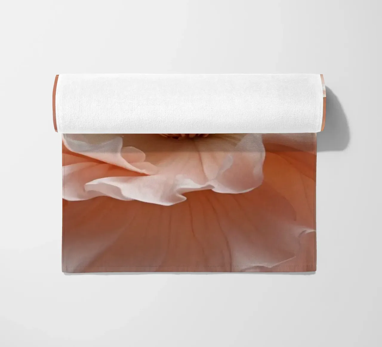 Delicate pink flower with ruffled petals illuminated in soft beach towel by DesignDoodle