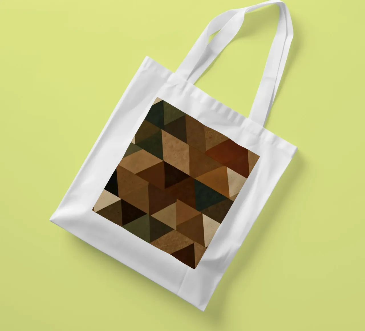 A geometric pattern of triangles in earthy tones arranged tote bag by DesignDoodle