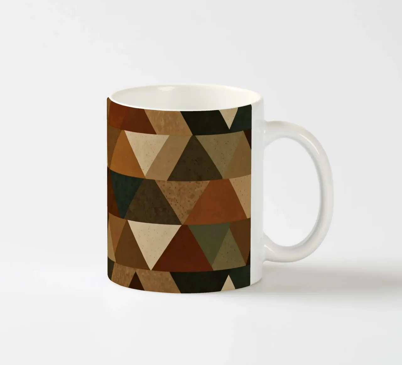 A geometric pattern of triangles in earthy tones arranged ceramic mug by DesignDoodle