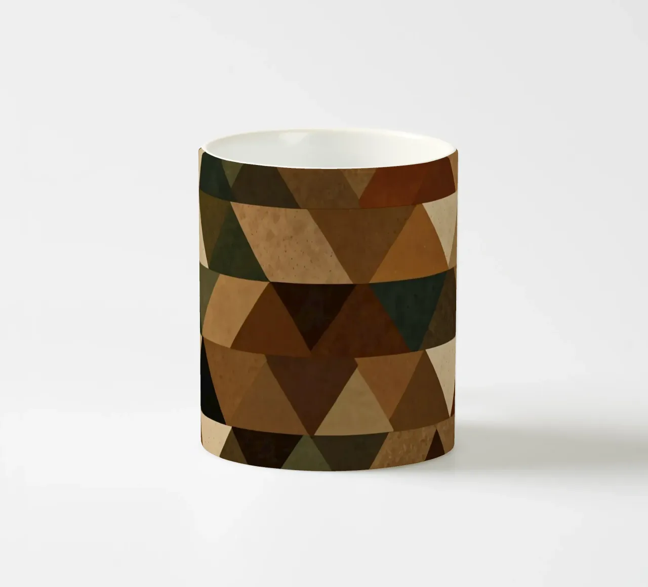 A geometric pattern of triangles in earthy tones arranged ceramic mug by DesignDoodle
