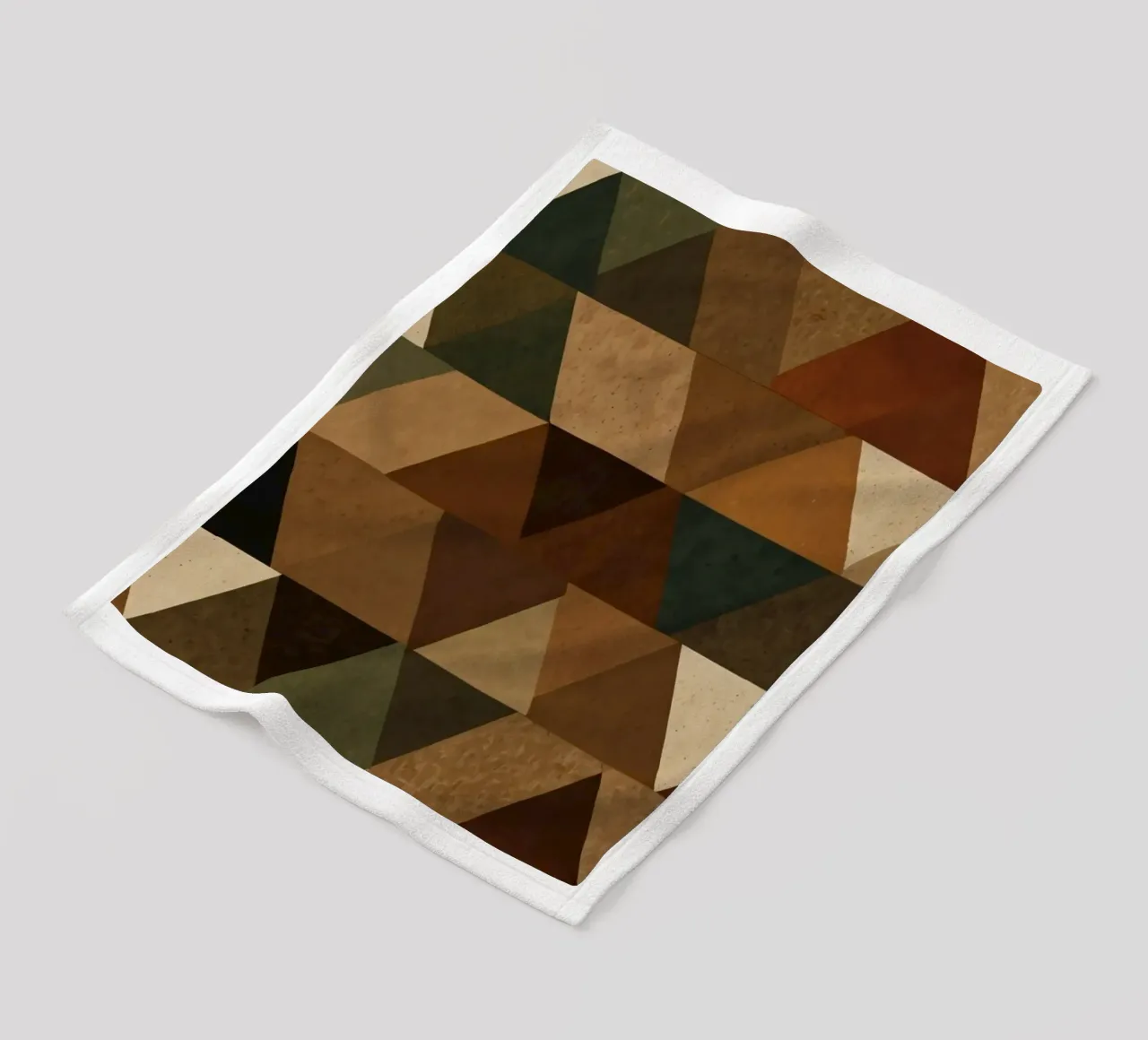 A geometric pattern of triangles in earthy tones arranged fleece blanket by DesignDoodle