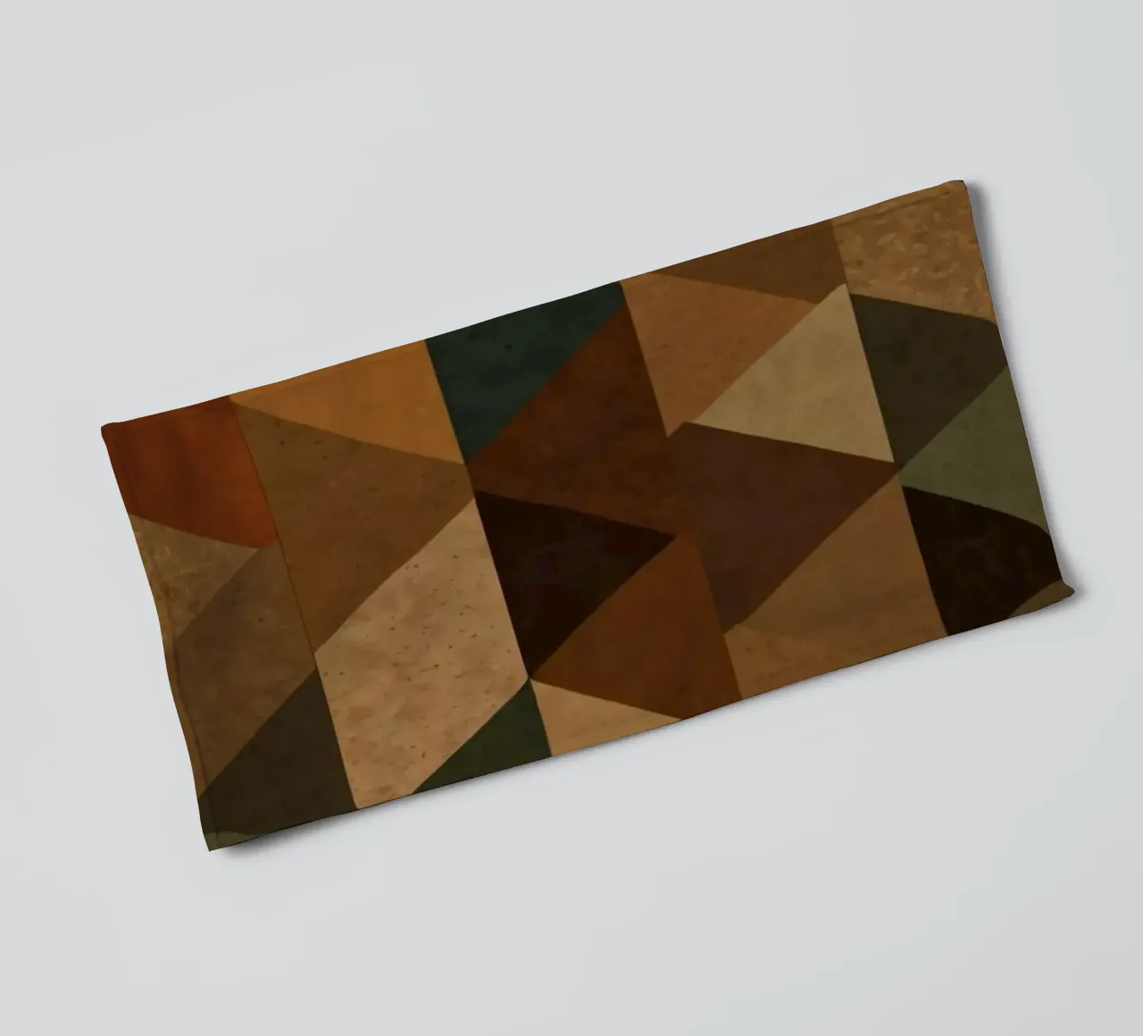 A geometric pattern of triangles in earthy tones arranged towel by DesignDoodle
