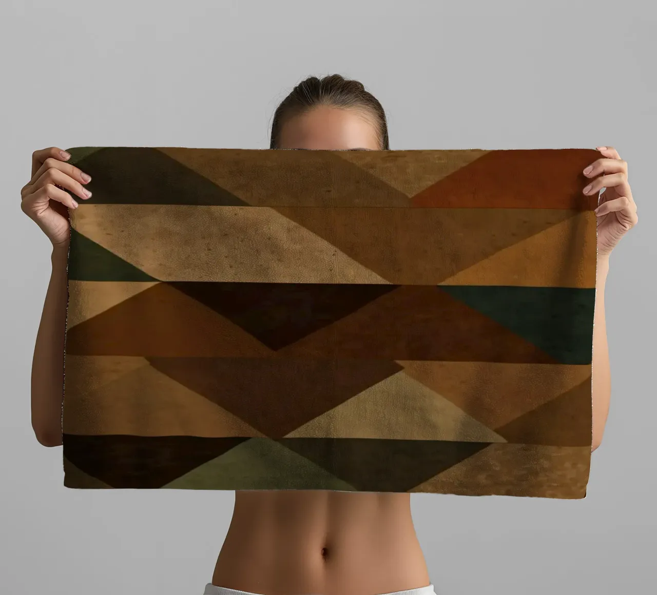 A geometric pattern of triangles in earthy tones arranged towel by DesignDoodle