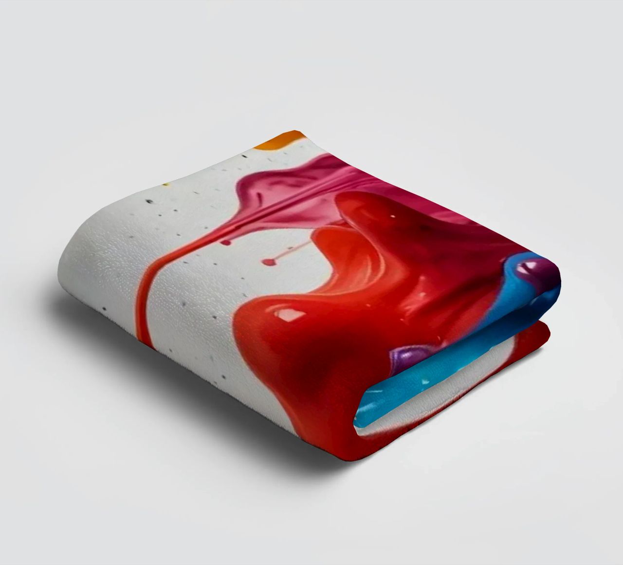 Kräftige Farbtropfen, die auf eine weiße Oberfläche tropfen und Handtuch von DesignDoodle