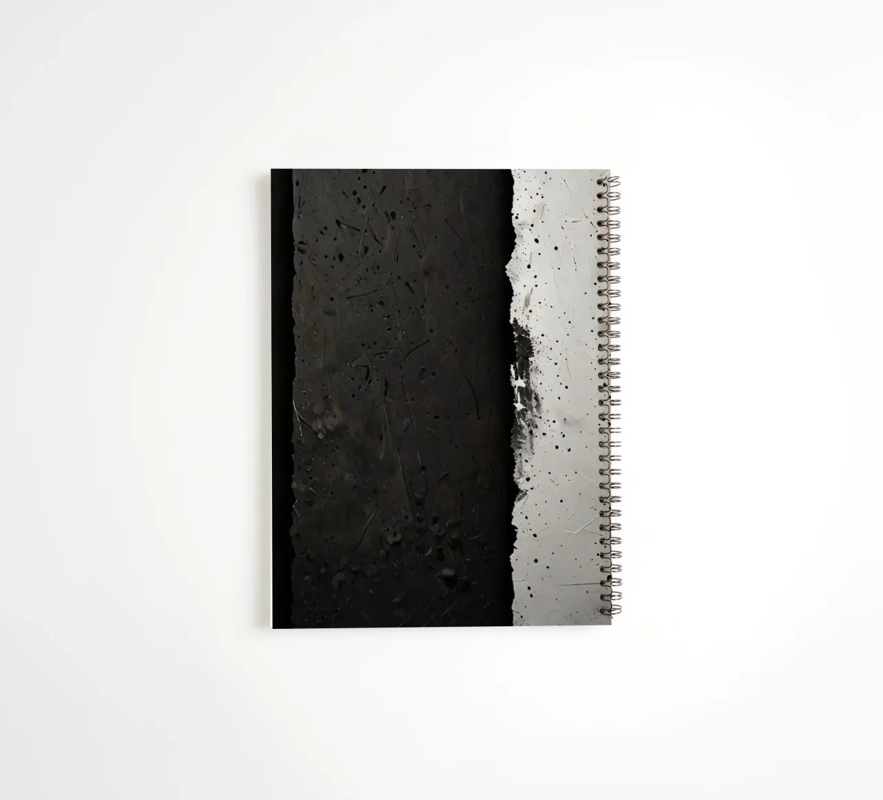 split in textured dark surfaces reveals an unexpected light spiral notebook by DesignDoodle