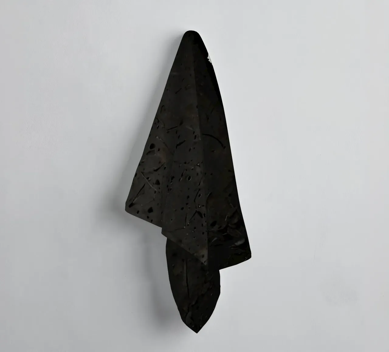 split in textured dark surfaces reveals an unexpected light towel by DesignDoodle