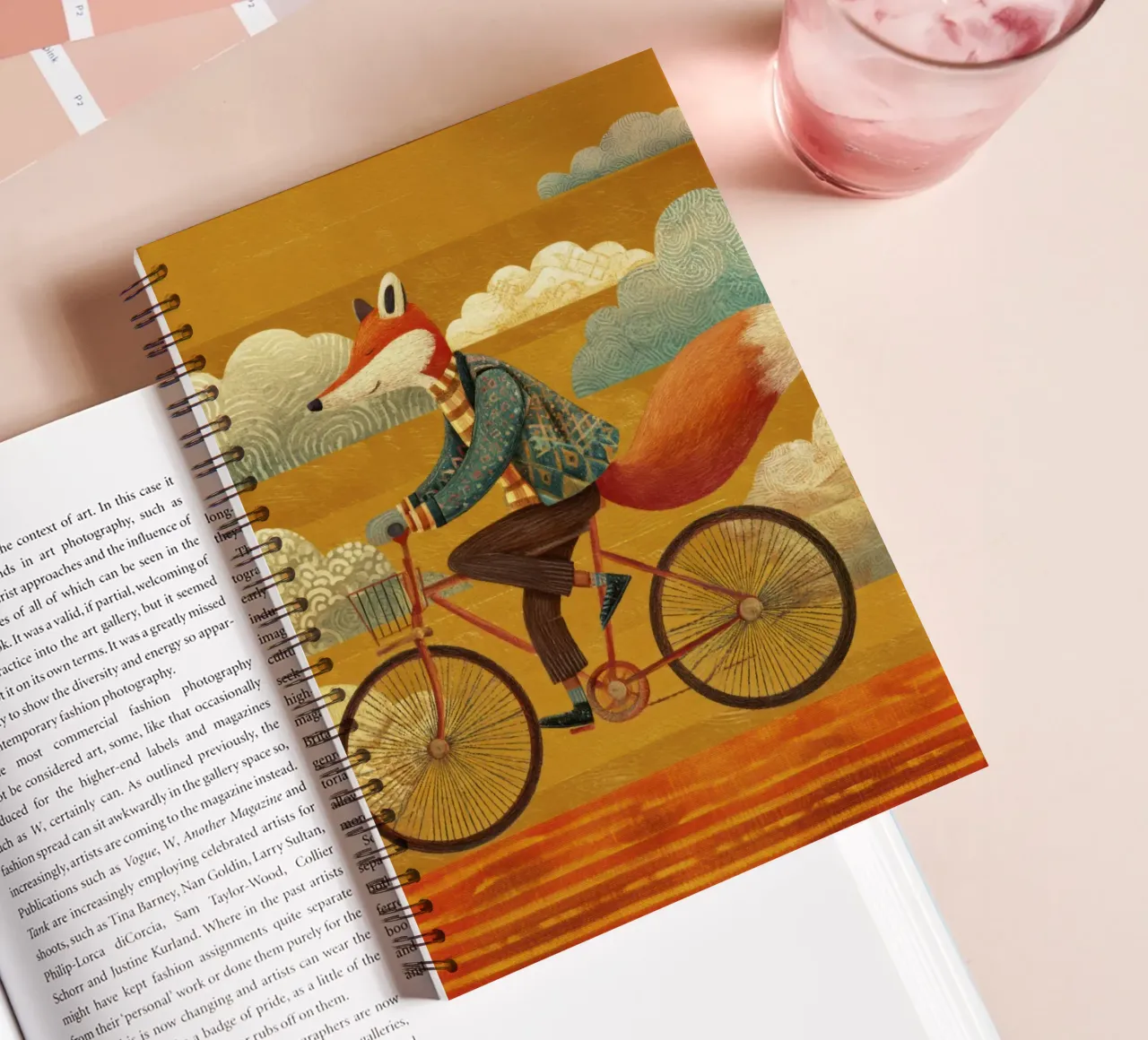 Whimsical Fox on Bike with Patterned Clouds and Orange Sky spiral notebook by Modern Muse