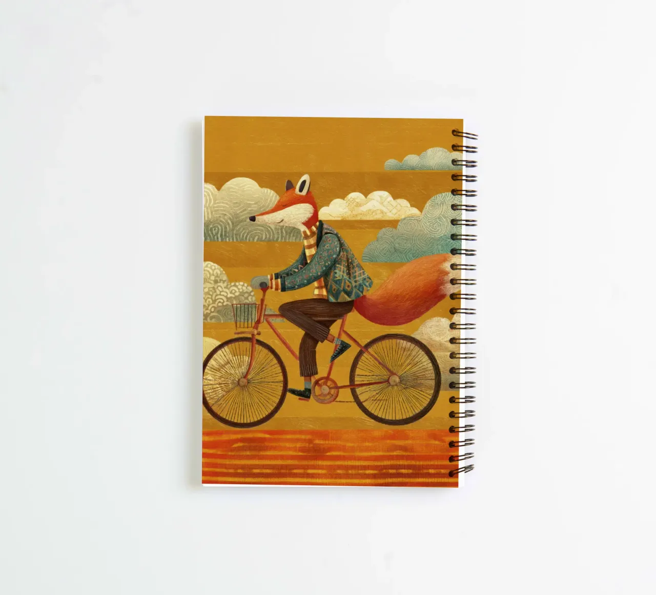 Whimsical Fox on Bike with Patterned Clouds and Orange Sky spiral notebook by Modern Muse