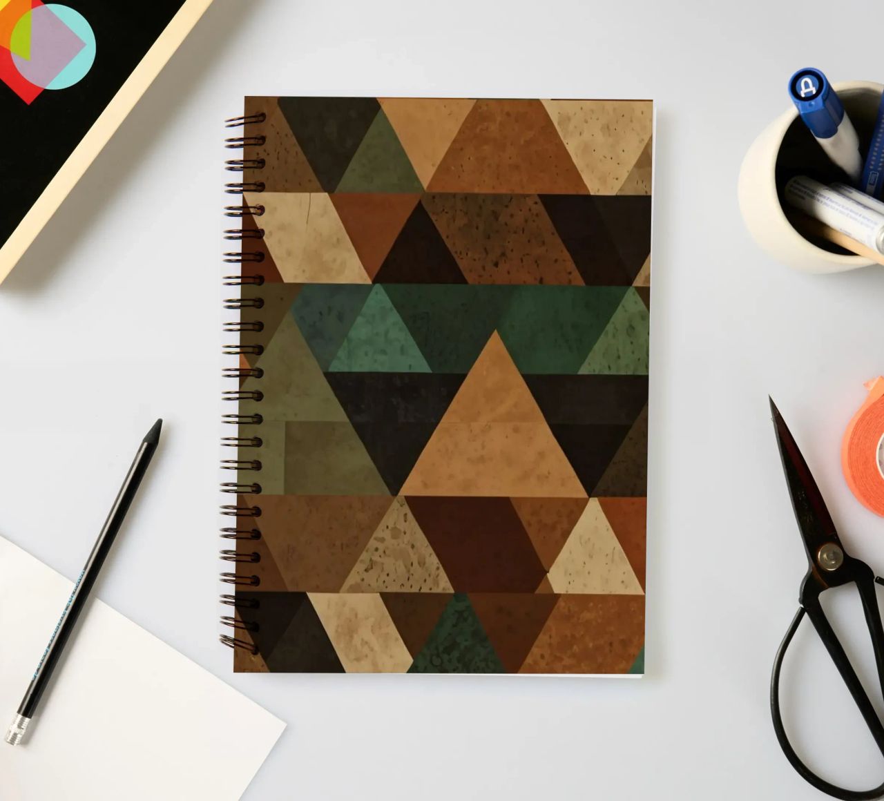 Colorful geometric pattern of alternating triangles in shade spiral notebook by DesignDoodle